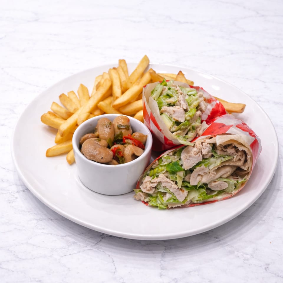Two chicken and lettuce wraps with a side of french fries and marinated mushrooms on a white plate.